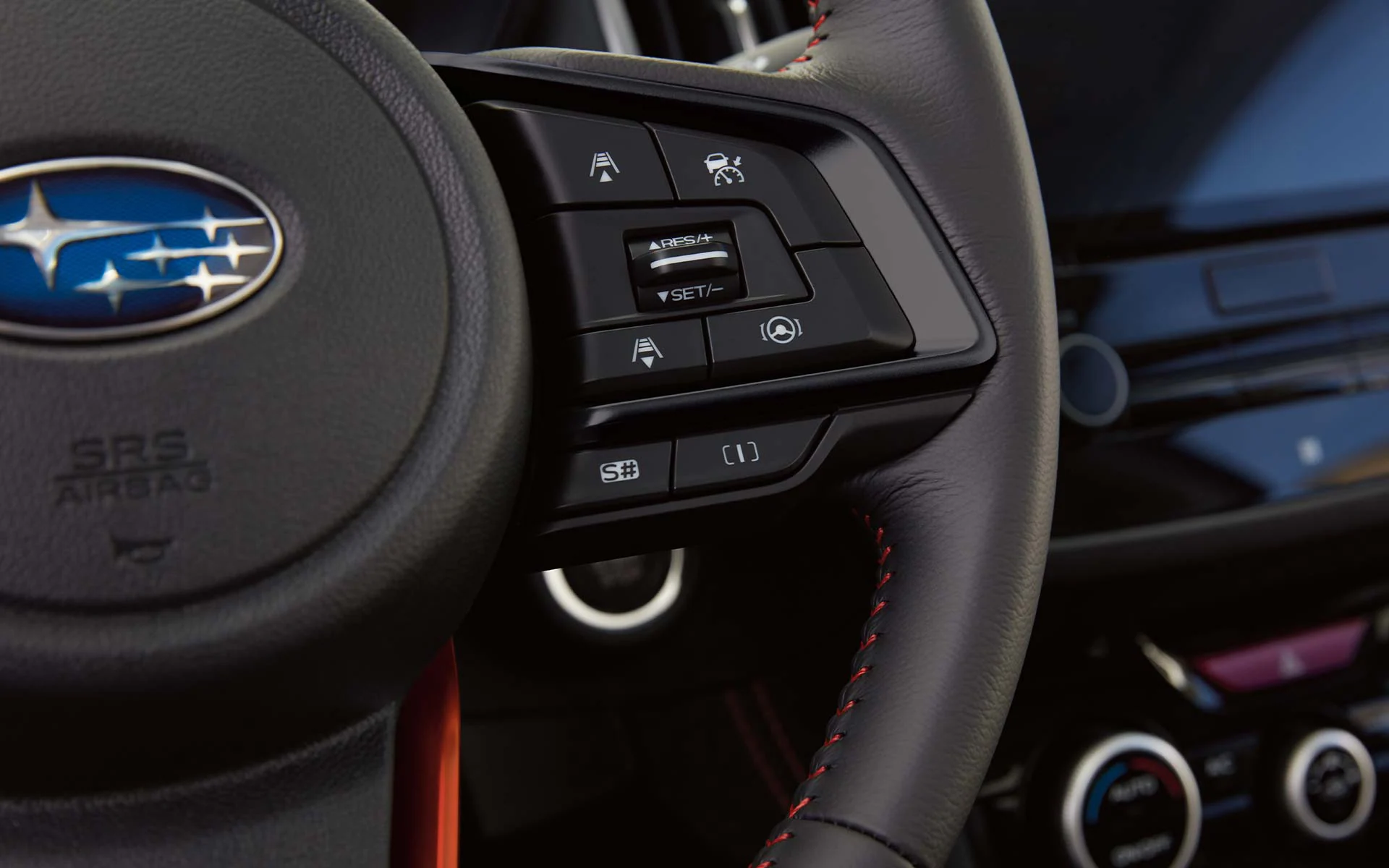 A close-up on the steering wheel controls for SI-DRIVE on the 2022 Forester Sport.